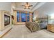 Comfortable bedroom with trey ceilings, a ceiling fan, large windows and luxurious bedding at 2597 Oak Vista Ct, Castle Rock, CO 80104
