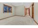 Spacious room with a large window, neutral carpet, and natural wood trim offering a serene living space at 2597 Oak Vista Ct, Castle Rock, CO 80104