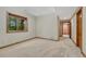 Spacious bedroom with neutral tones, carpeted floors, wooden trim and a hallway view at 2597 Oak Vista Ct, Castle Rock, CO 80104