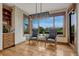 A cozy dining area with an elegant light fixture, comfortable seating, and scenic backyard views at 2597 Oak Vista Ct, Castle Rock, CO 80104