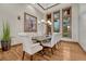 Dining room boasts large windows, hardwood floors, and a stylish chandelier above the dining table at 2597 Oak Vista Ct, Castle Rock, CO 80104