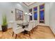 Formal dining room featuring hardwood floors, large windows, and stylish furnishings at 2597 Oak Vista Ct, Castle Rock, CO 80104