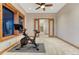 Exercise room with stationary bike, ceiling fan, and large window for ventilation and enjoying the outdoor view at 2597 Oak Vista Ct, Castle Rock, CO 80104