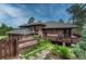 Charming home features a landscaped yard, stone accents, and a spacious deck for outdoor living at 2597 Oak Vista Ct, Castle Rock, CO 80104