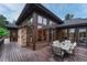 Exterior view of a well-designed home with a stone and wood facade and an outdoor dining area at 2597 Oak Vista Ct, Castle Rock, CO 80104