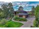 Beautiful home with lush landscaping, a stone-accented facade, and a large driveway leading to the garage at 2597 Oak Vista Ct, Castle Rock, CO 80104
