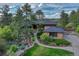 Beautiful home exterior with stone accents, lush landscaping, and a charming water feature at 2597 Oak Vista Ct, Castle Rock, CO 80104