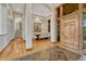 Elegant foyer with hardwood floors, an arched entry, and views into the dining room at 2597 Oak Vista Ct, Castle Rock, CO 80104