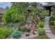 Lush, landscaped front yard with a rock waterfall feature, a pond, and a stone walkway leading to the home's entrance at 2597 Oak Vista Ct, Castle Rock, CO 80104