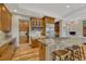 Gourmet kitchen featuring granite counters, a center island with seating, and custom wood cabinetry at 2597 Oak Vista Ct, Castle Rock, CO 80104