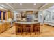 Spacious kitchen features a granite island, wood cabinets, stainless steel appliances, and hardwood floors at 2597 Oak Vista Ct, Castle Rock, CO 80104