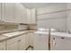 Laundry room with white cabinets, utility sink, and washer and dryer hookups at 2597 Oak Vista Ct, Castle Rock, CO 80104