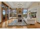 Spacious living room featuring a stone fireplace, hardwood floors, and large windows with natural light at 2597 Oak Vista Ct, Castle Rock, CO 80104
