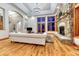 Inviting living room with hardwood floors, stone fireplace, and access to outdoor views at 2597 Oak Vista Ct, Castle Rock, CO 80104