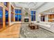 Spacious living room with a stone fireplace, hardwood floors, and plenty of natural light at 2597 Oak Vista Ct, Castle Rock, CO 80104