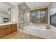 Spa-like main bathroom featuring a soaking tub, a glass shower, and a fireplace at 2597 Oak Vista Ct, Castle Rock, CO 80104