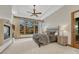 A serene main bedroom suite with a fireplace, tray ceilings, and large windows with scenic views at 2597 Oak Vista Ct, Castle Rock, CO 80104