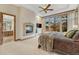 Comfortable main bedroom with a fireplace, large windows and an adjacent main bathroom suite at 2597 Oak Vista Ct, Castle Rock, CO 80104