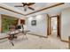 A home office with tray ceilings, wood trim and a large window with wooded views at 2597 Oak Vista Ct, Castle Rock, CO 80104