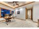 Cozy office space with tray ceilings, ceiling fan, a large desk, and direct hallway access at 2597 Oak Vista Ct, Castle Rock, CO 80104
