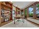 Home office with built-in bookshelves, a large window, and a private outdoor balcony at 2597 Oak Vista Ct, Castle Rock, CO 80104