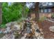 Scenic waterfall feature cascading through a rock garden, adding a touch of nature to the property at 2597 Oak Vista Ct, Castle Rock, CO 80104