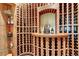 Custom wine cellar with wooden shelves, arches, and racks for storing wine bottles and other beverages at 2597 Oak Vista Ct, Castle Rock, CO 80104