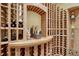 Close-up of wine cellar with wood storage and custom shelving at 2597 Oak Vista Ct, Castle Rock, CO 80104