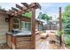 Inviting back patio with outdoor kitchen, seating, and stylish pergola at 7579 Jay Ct, Arvada, CO 80003