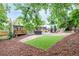 Large backyard with a well manicured lawn, mature trees, and a hot tub. Includes a wooden deck and outdoor seating at 7579 Jay Ct, Arvada, CO 80003