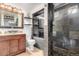 Modern bathroom featuring stylish vanity, updated toilet, and slate-tiled walk-in shower with river rock floor at 7579 Jay Ct, Arvada, CO 80003