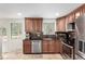 Well-appointed kitchen with stainless steel appliances, granite countertops, and abundant cabinetry at 7579 Jay Ct, Arvada, CO 80003
