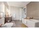 Bathroom featuring a modern soaking tub, sleek vanity, and neutral tile at 4200 W 17Th Ave # 508, Denver, CO 80204