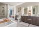 Bathroom featuring double sink vanity, soaker tub, walk-in shower, and an open design at 4200 W 17Th Ave # 508, Denver, CO 80204