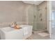 Elegant bathroom featuring a soaking tub and glass enclosed shower at 4200 W 17Th Ave # 508, Denver, CO 80204