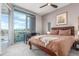 Bedroom featuring a large window with scenic views, a ceiling fan, and a comfortable bed at 4200 W 17Th Ave # 508, Denver, CO 80204