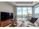 Sunlit living room with floor-to-ceiling windows showcasing panoramic views of the city and mountains at 4200 W 17Th Ave # 508, Denver, CO 80204