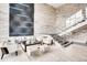 Modern lobby area features stylish seating, high ceilings, and a staircase with glass railings at 4200 W 17Th Ave # 508, Denver, CO 80204