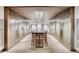 Mailroom with lockers and a long wooden table with chairs and modern lighting at 4200 W 17Th Ave # 508, Denver, CO 80204