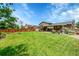 Expansive backyard with lush lawn and a covered patio ideal for outdoor living at 9225 Lowell Blvd, Westminster, CO 80031