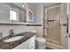 Modern bathroom featuring a granite countertop, matching framed mirror, and walk-in shower at 9225 Lowell Blvd, Westminster, CO 80031