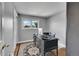 Small bedroom features a desk, a black chair and a window with outside view for a study space at 9225 Lowell Blvd, Westminster, CO 80031
