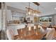 Open dining room with a decorative light fixture and view into an updated kitchen and living room at 9225 Lowell Blvd, Westminster, CO 80031