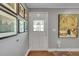 Bright foyer featuring hardwood floors, a decorative stained glass front door, and stylish wall decor at 9225 Lowell Blvd, Westminster, CO 80031