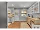 Stylish kitchen featuring hardwood floors, white cabinets, modern appliances, and abundant natural light at 9225 Lowell Blvd, Westminster, CO 80031