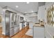 Well-equipped kitchen with stainless steel appliances, granite countertops, white cabinets and hardwood flooring at 9225 Lowell Blvd, Westminster, CO 80031