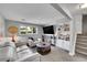 Spacious living room with modern furnishings and a built-in bookcase at 9225 Lowell Blvd, Westminster, CO 80031