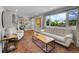 Bright living room with hardwood floors, large windows, and ample seating, creating a cozy atmosphere at 9225 Lowell Blvd, Westminster, CO 80031
