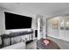Inviting living room showcases a large TV and built-in bookshelves at 9225 Lowell Blvd, Westminster, CO 80031