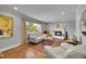 Inviting living room with hardwood floors, large windows, a cozy fireplace, and neutral colored walls at 9225 Lowell Blvd, Westminster, CO 80031
